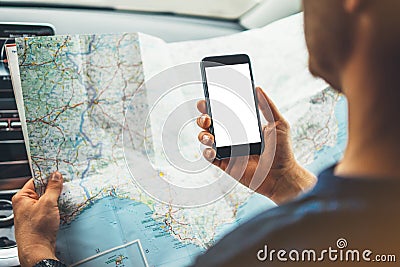 Hipster man looking on navigation map in car, tourist traveler driving and holding in male hands smartphone gps with clean screen Stock Photo