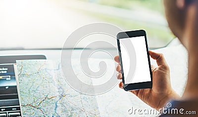 Hipster man looking on navigation map in car, tourist traveler driving and holding in male hands smartphone gps with clean screen Stock Photo