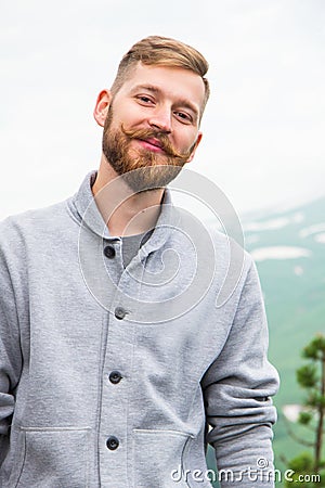 Hipster Man on top of mountain. Conceptual design. Stock Photo