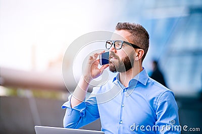 Hipster manager with smart phone, London City Hall Stock Photo