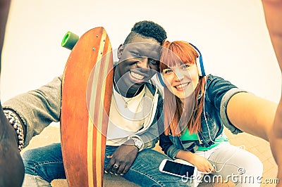 Hipster multiracial love couple taking urban fashion selfie Stock Photo