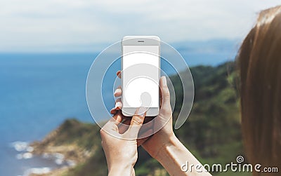 Hipster photograph on smart phone gadget mobile, mock up of blank screen. Traveler hold and using in female hand mobile on backgro Stock Photo