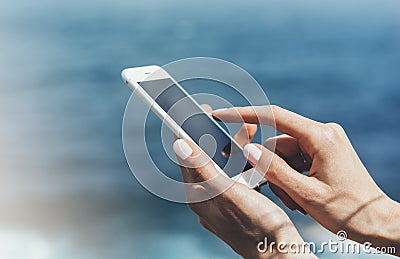 Hipster photograph on smart phone gadget mobile, mock up of blank screen. Traveler hold and using in female hand mobile Stock Photo