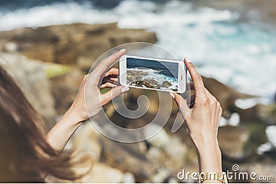 Hipster photograph on smart phone gadget mobile, mock up of blank screen. Traveler hold and using in female hand mobile on back Stock Photo