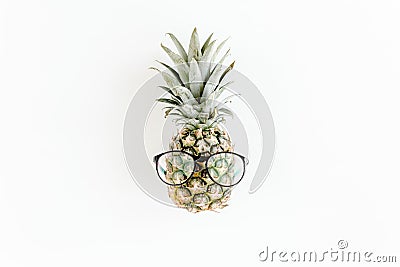 Hipster pineapple in glasses on white background. Flat lay, top view Stock Photo