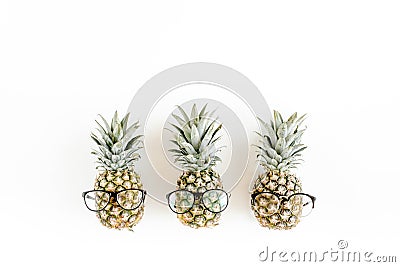 Hipster pineapples in glasses on white background. Flat lay, top view Stock Photo