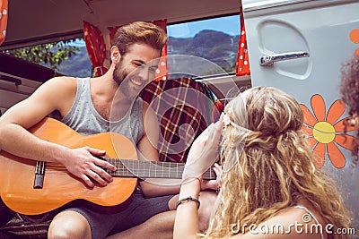 Hipster playing guitar for girls Stock Photo