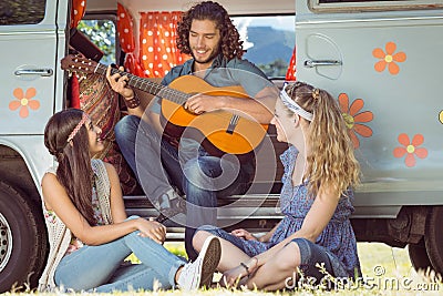 Hipster playing guitar for girls Stock Photo