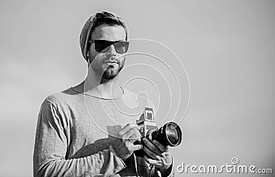 Hipster reporter taking photo. Photojournalist concept. Travel blogger. Professional photographer. Handsome photographer Stock Photo