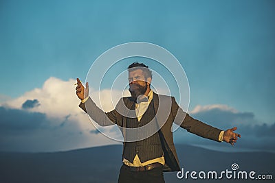 Hipster with stylish appearance in front of dramatic sky, Stock Photo