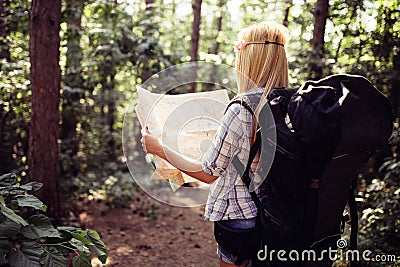 Hipster tourist woman with map hiking, lifestyle adventure concept Stock Photo