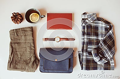 hipster or traveller woman casual fashion set flat lay. Plaid shirt, blue cross body bag and khaki pants Stock Photo