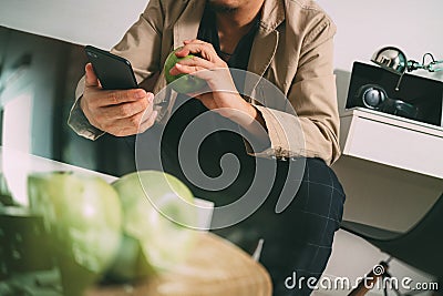 hipster using smart phone and digital tablet computer and holding credit card payments online business,sitting on sofa in living Stock Photo