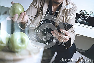 hipster using smart phone and digital tablet computer and holding credit card payments online business,sitting on sofa in living Stock Photo