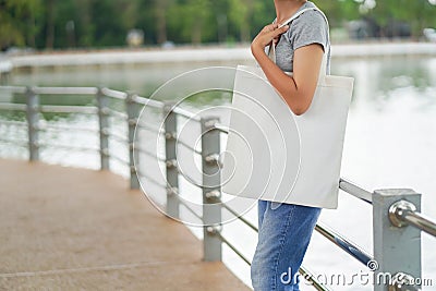 hipster woman holding white tote bag for mock up blank template Stock Photo