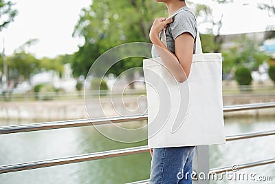 hipster woman holding white tote bag for mock up blank template Stock Photo