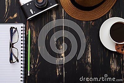 Hipster working table - vintage camera, hat, eyeglasses, notepad Stock Photo