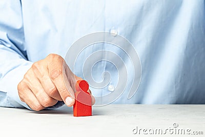 Hiring employees. How to choose a good employee leader. Man in a shirt holds figures in his hands. Copy space for text Stock Photo