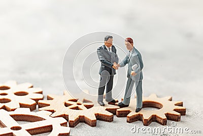 Hiring staff. Selection of the leader of the manager for the company. Businessmen in suits shake hands on gears as a Stock Photo