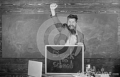 Hiring teachers for new school year. Back to school teachers recruitment. Man bearded holds blackboard inscription back Stock Photo
