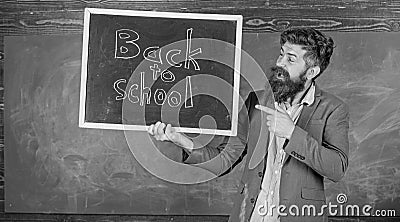 Hiring teachers for new school year. Man bearded holds blackboard inscription back to school. Back to school teachers Stock Photo