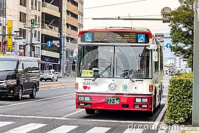 Apanese public bus stopped at the crosswalk line in Hiroshima, Japan. Editorial Stock Photo