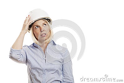 Young woman in a blue shirt and white construction helmet. Isolated over white background. Close-up Stock Photo