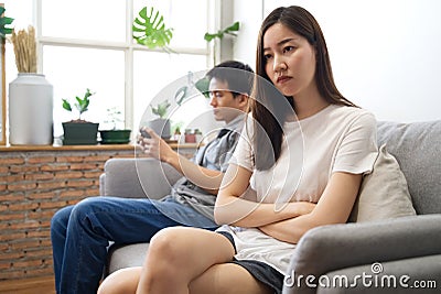 Young girl sitting on sofa is feeling angry her boyfriend. Stock Photo