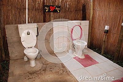 His and Hers outdoor toilets Stock Photo