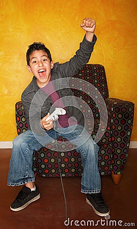 Hispanic Boy Playing Video Game Stock Photo