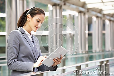 Hispanic Businesswoman Working On Tablet Computer Stock Photo