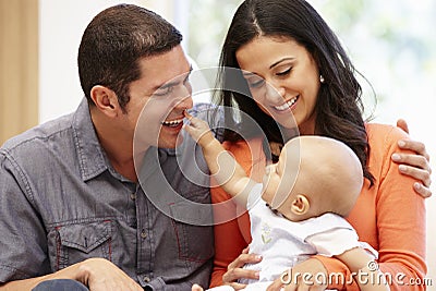 Hispanic couple at home with baby Stock Photo