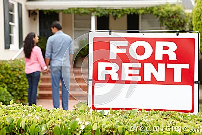 Hispanic couple outside home for rent Stock Photo