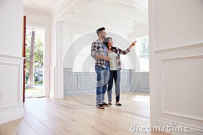 Hispanic Couple Viewing Potential New Home Stock Photo