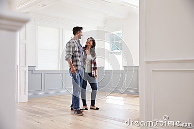 Hispanic Couple Viewing Potential New Home Stock Photo