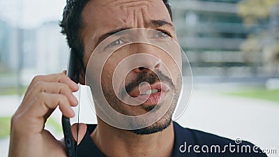 Hispanic director talking phone call at street closeup. Stressed man disputing Stock Photo