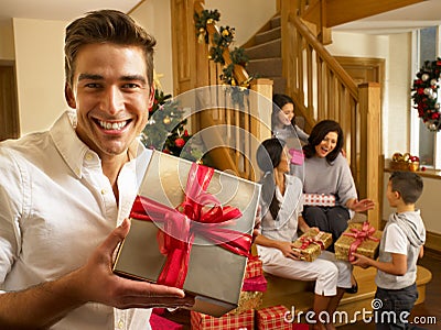 Hispanic family exchanging gifts at Christmas Stock Photo