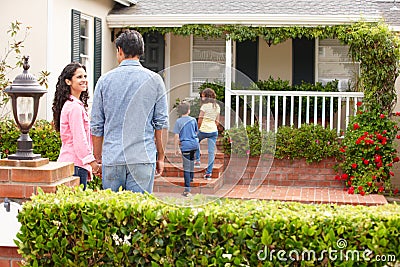 Hispanic family outside home for rent Stock Photo