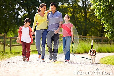 Hispanic Family Taking Dog For Walk Stock Photo