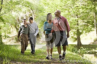 Hispanic family walking along trail in park Stock Photo