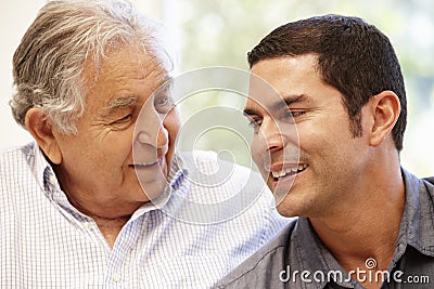 Hispanic father and adult son Stock Photo