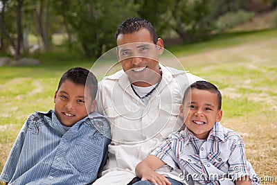 Hispanic Father and Sons in the Park Stock Photo