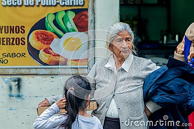 Hispanic Grandmother Buying A Pizza For Her Granddaughter Editorial Stock Photo