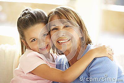 Hispanic Grandmother And Granddaughter Relaxing At Home Stock Photo