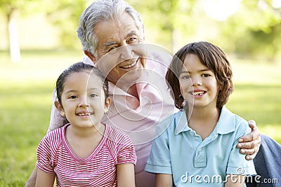 Hispanic Grandmother And Grandfather Relaxing With Grandson In P Stock Photo