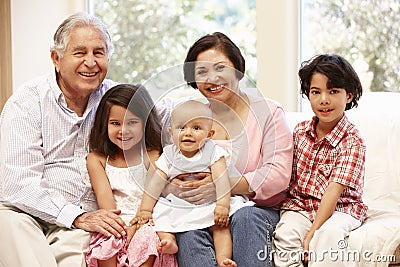 Hispanic grandparents at home with grandchildren Stock Photo