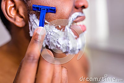 hispanic man put on foam on beard perfume lotion or skin care cream for sensitive skin Stock Photo