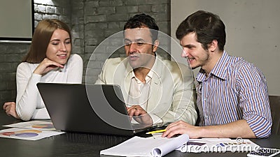 Hispanic mature businessman helping his employees during business meeting Stock Photo