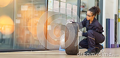 hispanic mechanic woman worker checking car tires in auto repair shop store service. latin female worker maintenance examining Stock Photo