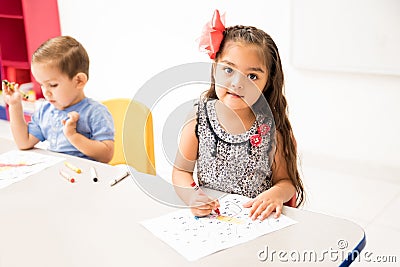 Hispanic preschool student coloring Stock Photo